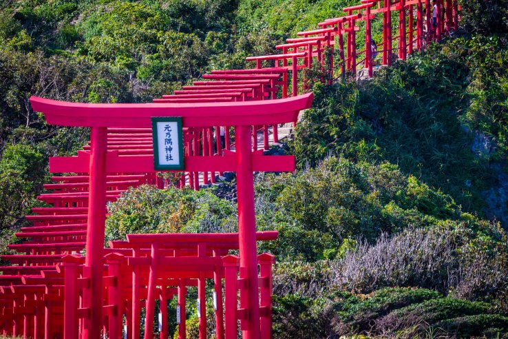 The classic large gate with the passage weaving up the green mountainside