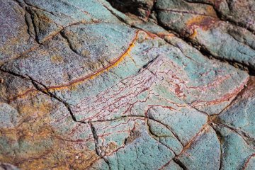 A rainbow of minerals appear on closer inspection of the rocky cliffs