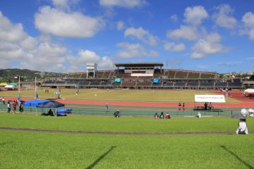 The stadium can hold 25,000 visitors between its auditorium style bleacher seating and surrounding grassy fields