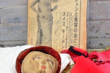 An old baby doll averts her eyes from the camera.