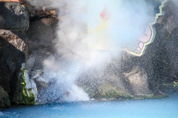 A close up of the front of the steam vent shot in high shutter speed. You can see lots of water being sprout together with the steam