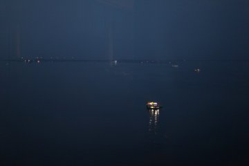 Gaze out at the eerie sea, where fisherman are still at work