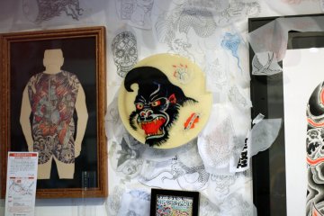 The shop is wallpapered in artwork.