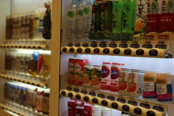 A host of vending machines providing a variety of beverages to quench your thirst.