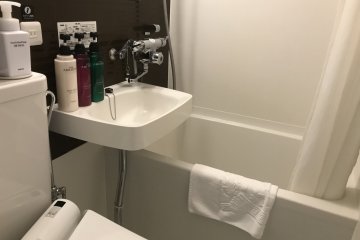 The bathroom is equipped with amenities like shampoo, conditioner and body wash, allowing you to pack light