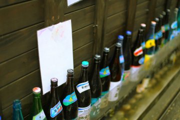 Sake bottles line the streets of a Daimyo izakaya