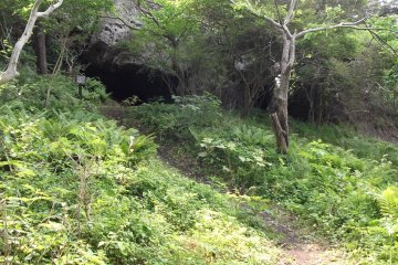 <p>A short side path takes you to a small cave with a miniature shrine inside</p>