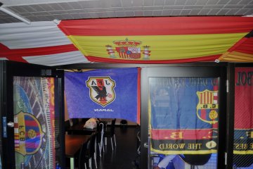 Different flags in the ceiling of the pub
