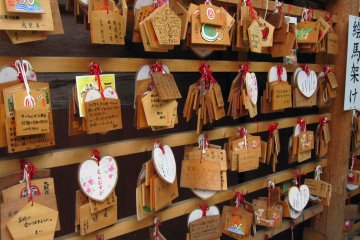 Here we see many ema—wooden wishing plaques.
