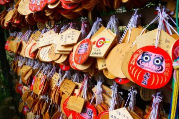 Visitors to the temple can buy wooden ornaments, write their own prayers and hang them here