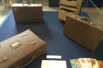 Climb the stairway from the first floor and you are greeted by aging travel cases.