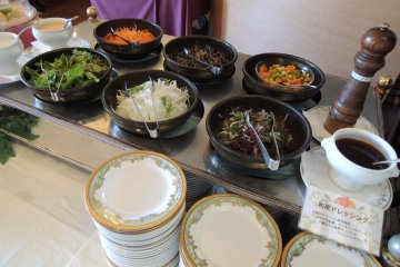 Variety of dressings and vegetables at the salad bar
