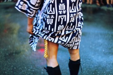 Traditional clothing is worn, including split toed boots