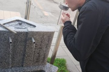 Trying the delicious local natural spring water