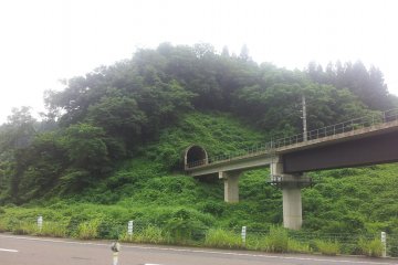 The train line disappears into the mountainside