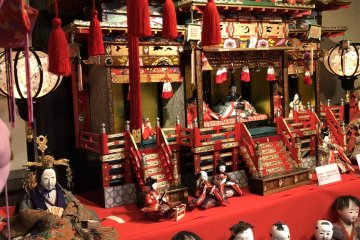 A set of hina-dolls in a miniature palace