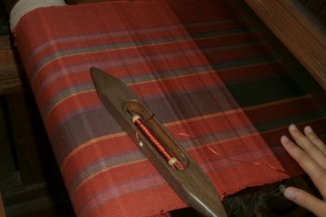 You throw this wooden object from one side to the other to weave in the weft