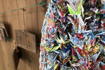 Paper cranes tucked away in a shopping street promenade
