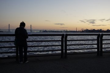 A guy painting the view of sun setting behind the harbor... I bet the result is amazing!