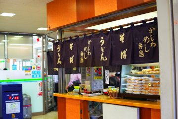 A hot food stall selling a wide range of noodles and meals