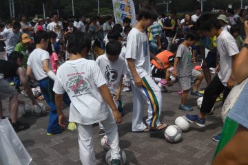 Kids gather around for a soccer lesson