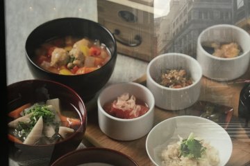 Poster outside the restaurant with the reflection of Nihonbashi's famous buildings.
