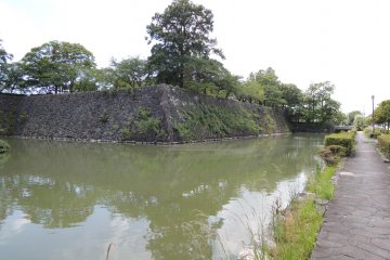 The moat surrounds the castle walls