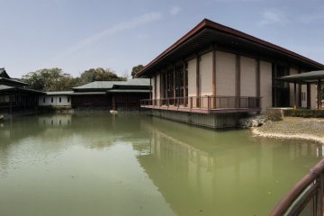 A large modern lake house, a contrast to the traditional red gates of the shrine
