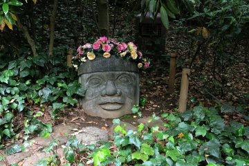 'Tribal' sculpture and flowers