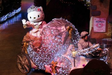 Hello Kitty waves to her adoring audience as she rides away in a chariot at the end of the performance.
