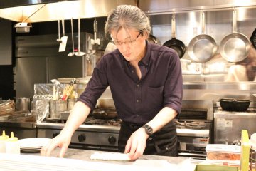 Yas preps the California-style sushi rolls