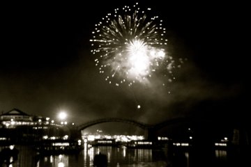 black and white shot shows a classic river scene in firework light