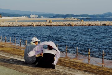 In the last hours of sunlight, people come here to enjoy the ocean breeze.