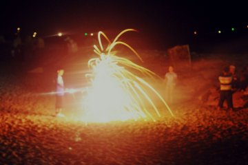 During the Tanabe Festival, at night, the beach was full of kids playing with firecrackers