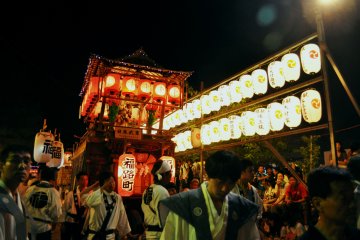 The surroundings of the shrine and of the Ginza commercial district are lit up at night.