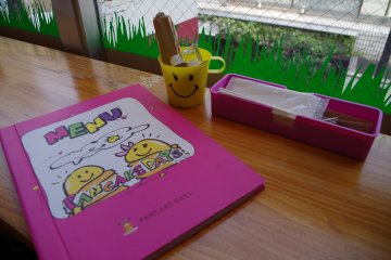 Sketchy smiling cartoon drawings at every corner at Pancake Days in Harajuku Bell Pier just moments from Omotesando and Meiji Jingumae.