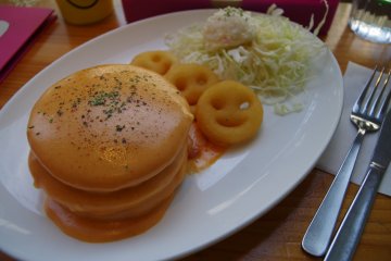 Creamy croque-monsieur pancake is a French-Japanese fusion dish. Cheese and ham sandwiched into three layers of pancakes. Spongy, creamy pancakes made well balance with shredded cabbage and potato salad, a hit for cheese lovers everywhere.