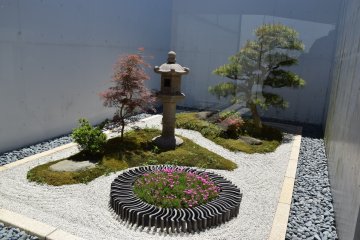 A small Japanese-style garden greeting visitors at the entrance of the museum