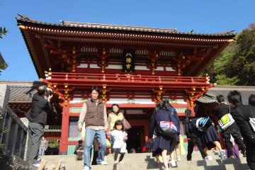 <p>If you come up to it, you will see a large black plate displayed under the eves of this building. The plate shows Hachi-man-gu written in large kanji characters. The first kanji is Hachi (eight) and it is designed to resemble a pair of doves.</p>