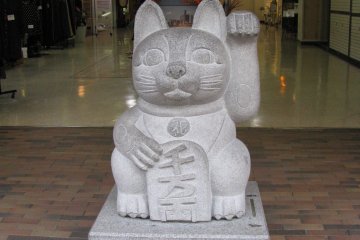 A stone maneki neko