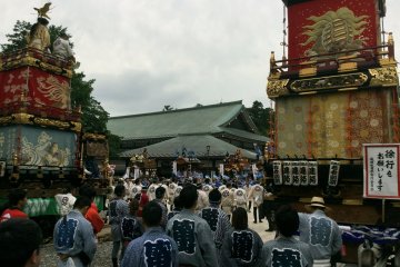 The opening ceremony with elaborate floats and participants in colorful clothing