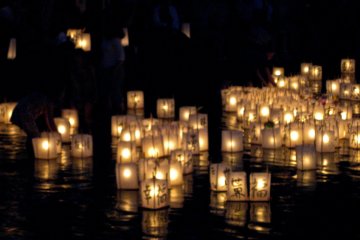 Paper lanterns floating down the river