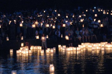 Participants releasing the lanterns into the river