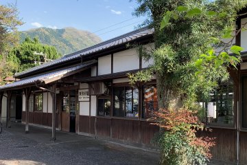 The entrance to Higashi Beppu Station, with Mount Takazaki in the background
