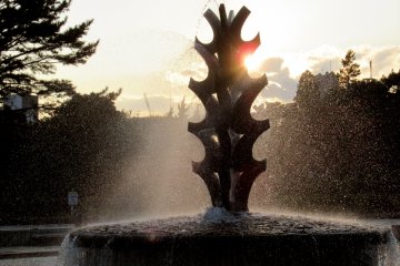A fountain in the rays of the setting sun