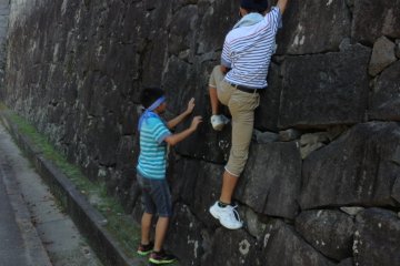 The steep walls of the castle were meant to keep out ruthless warriors. Let's hope they can keep curious Japanese children out too!