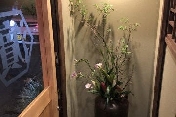 Beauty at the door, flowers and blossoms in a vase
