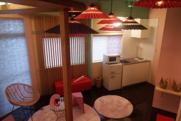 The living area connects to mini fridge and kitchen.