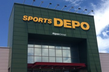 Sports Depo's large sign towers above its large warehouse style big box store underneath