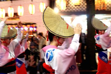Traditional dancers in hats at the Hanagasa Matsuri